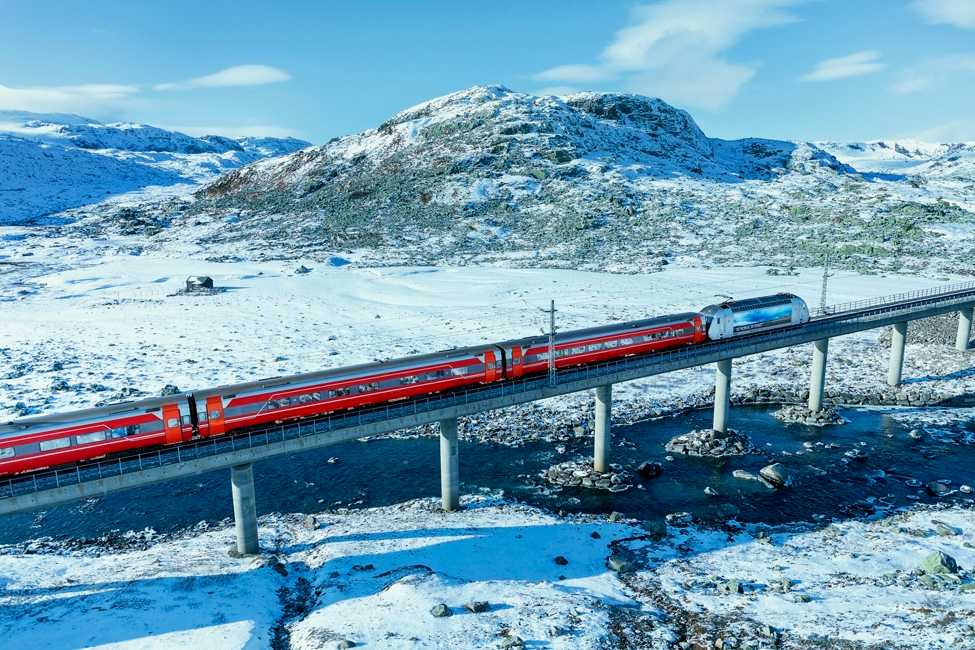 Tog som kjører i vinterlandskap